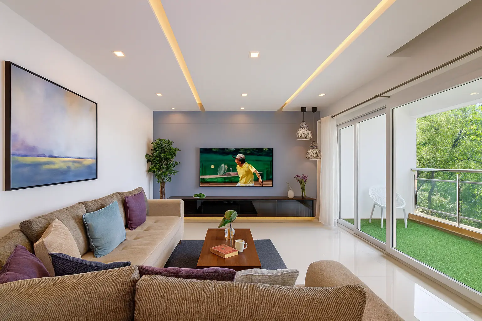 Elegant living room with LED lighting, neutral tones, and contemporary wall art